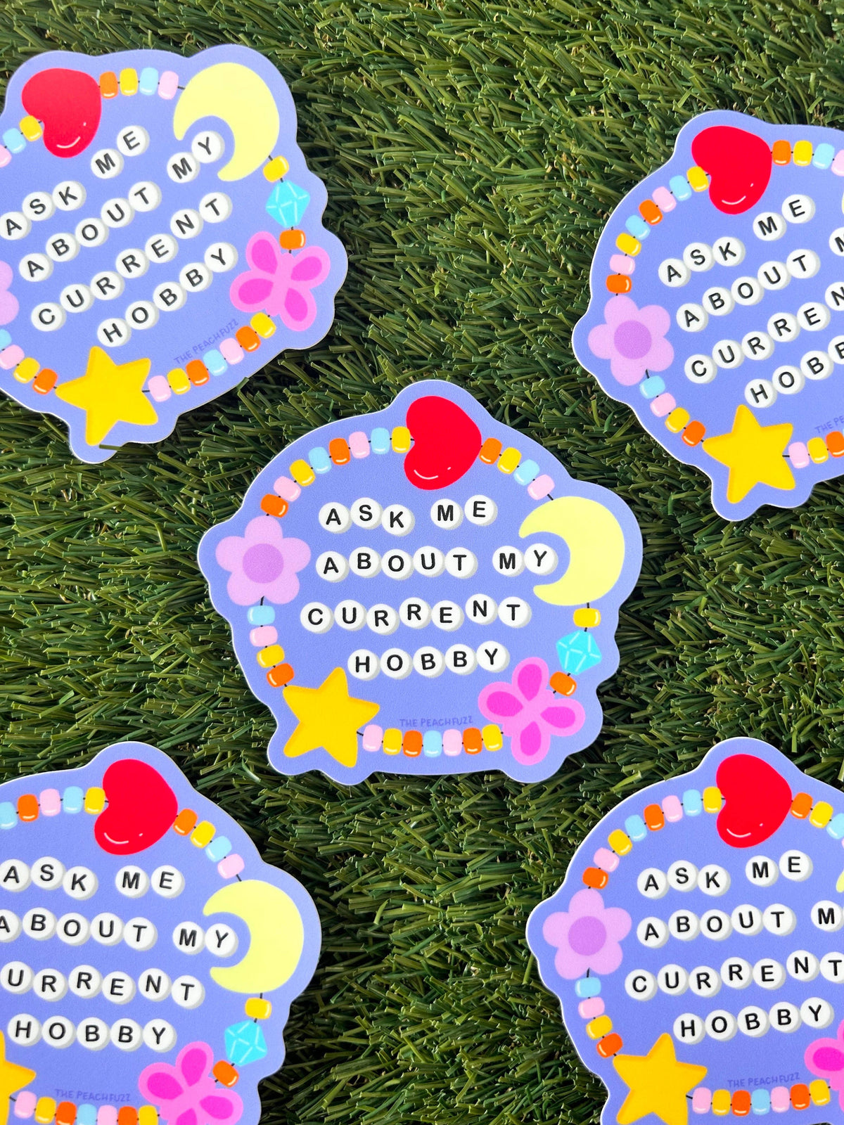 The Peach Fuzz Ask Me About My Current Hobby stickers on green