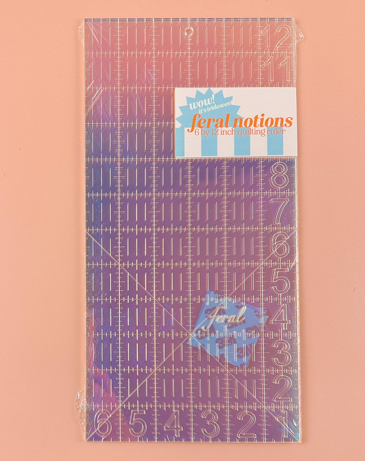Feral Notions 6 x 12 inch quilting ruler in iridescent acrylic with its label, a patchwork and quilting tool