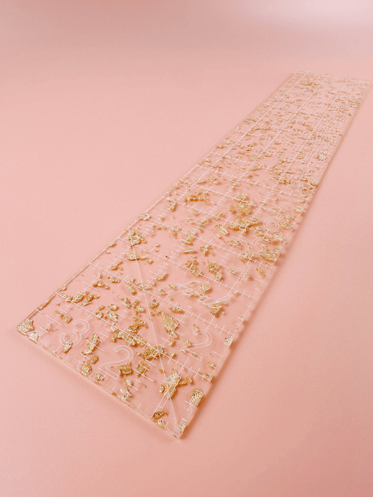 Feral Notions fat quarter quilting ruler in gold glitter clear acrylic on a peach background