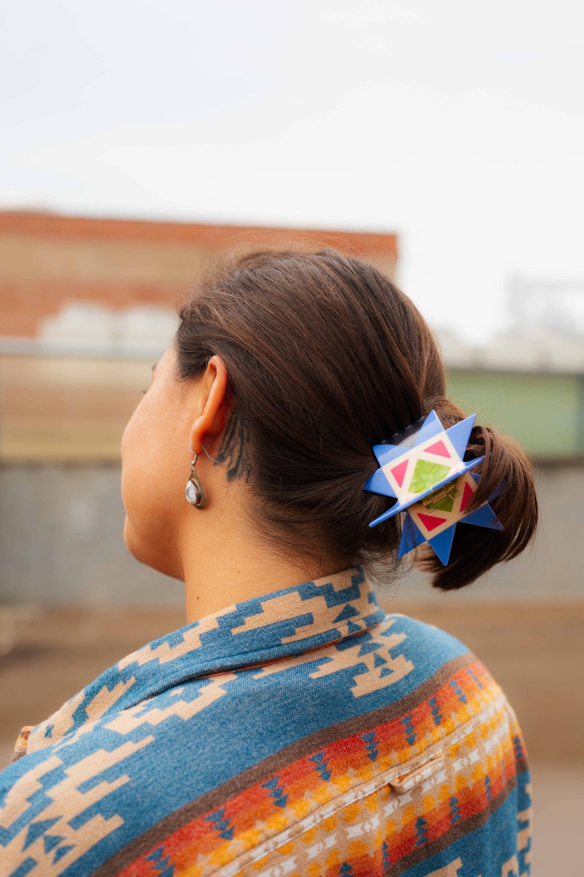 The Peach Fuzz quilt hair claw worn in a low bun, a gift for quilters