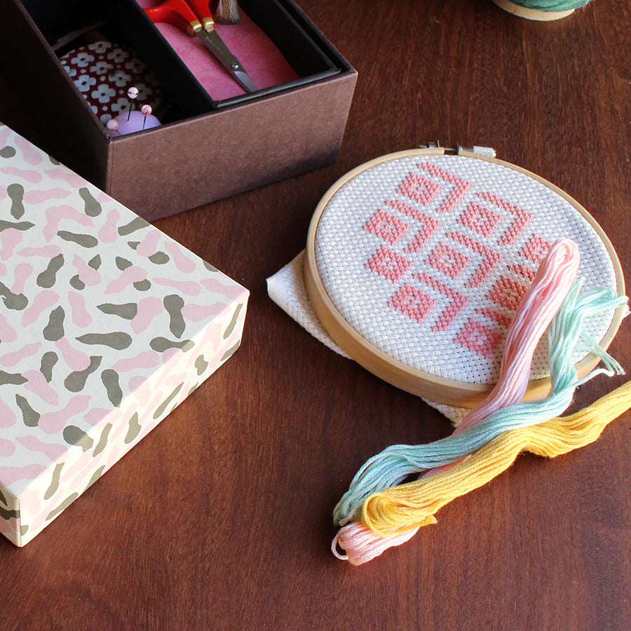 Cohana assorted needles in a Haibara chiyogami paper pack, with thread on fabric