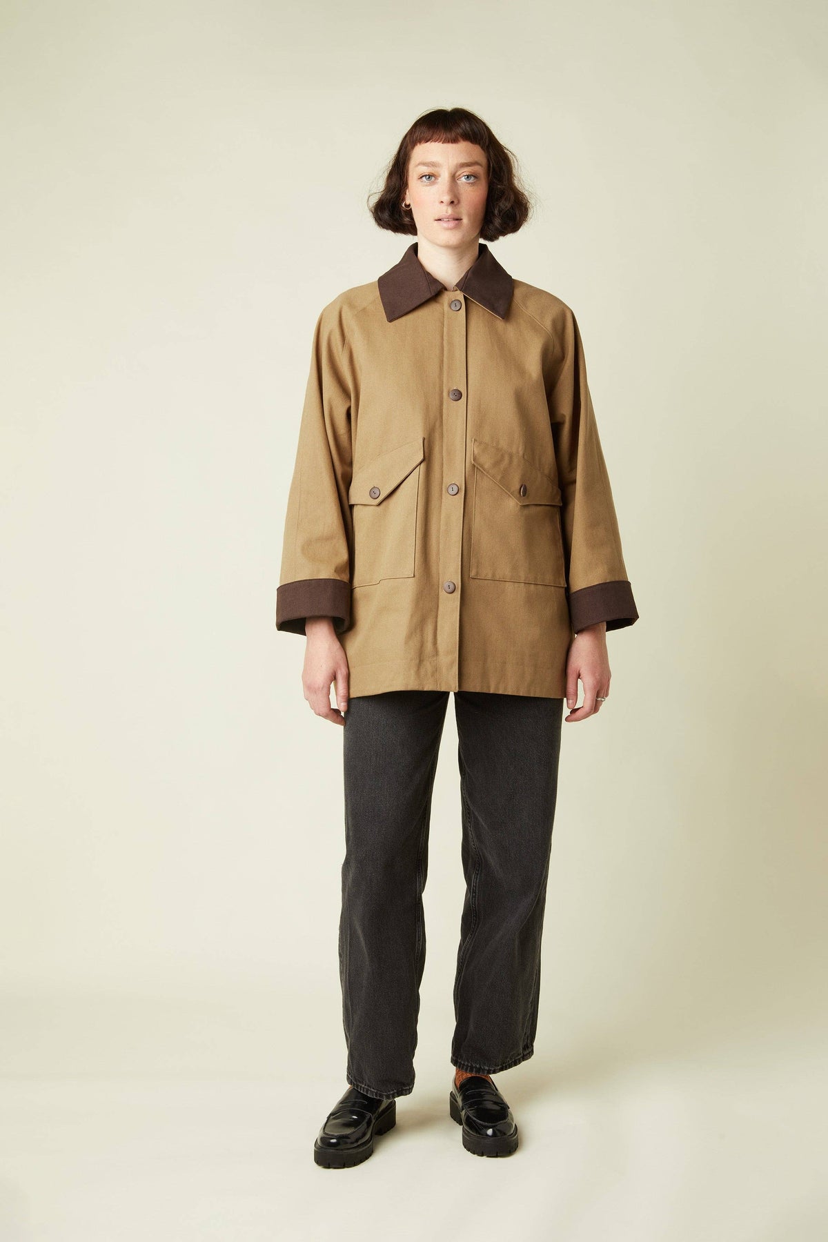 Model in a tan barn jacket and grey trousers sewn from the Atelier Brunette LA Barn Jacket printed sewing pattern