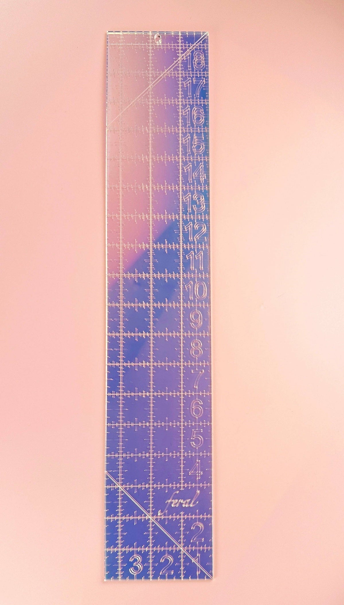 Feral Notions fat quarter quilting ruler in iridescent purple and blue acrylic standing upright