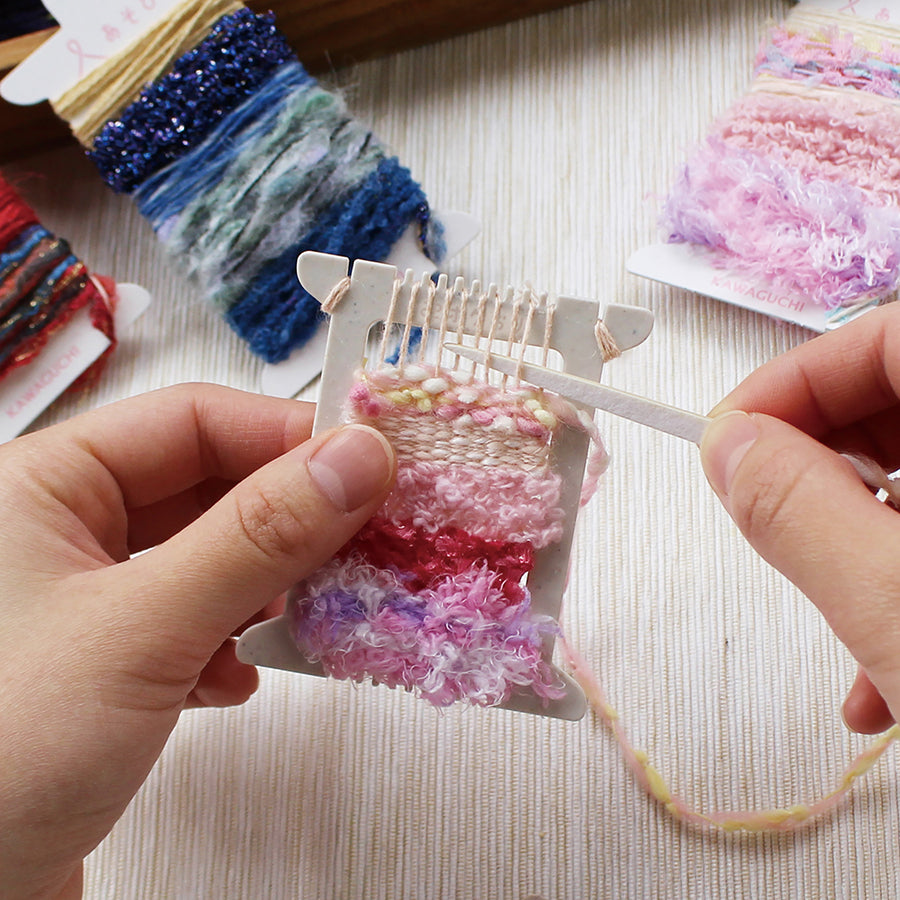 Cohana Pokeori mini loom weaving kit, with hands weaving on the loom