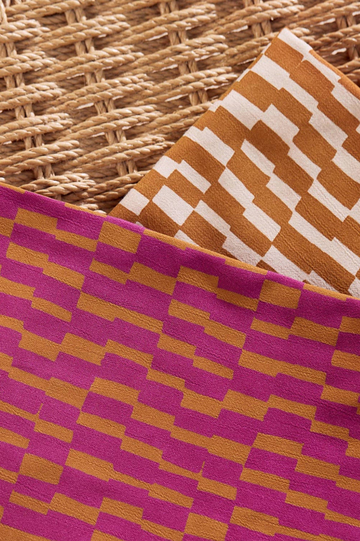 Atelier Brunette Domino Ochre viscose folded with pink fabric for dressmaking