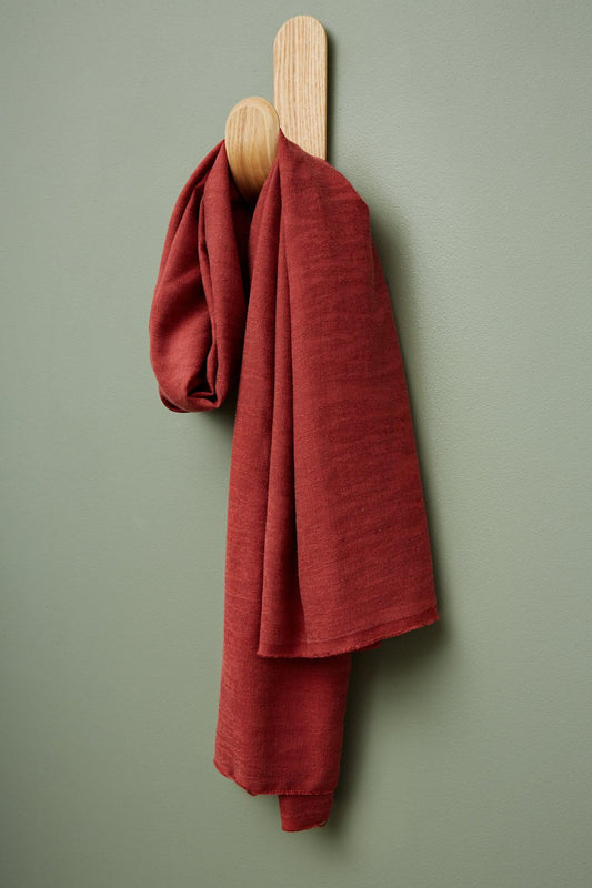 meetMILK Hoya jacquard linen blend in Cider, red textured dressmaking fabric hanging on a hook