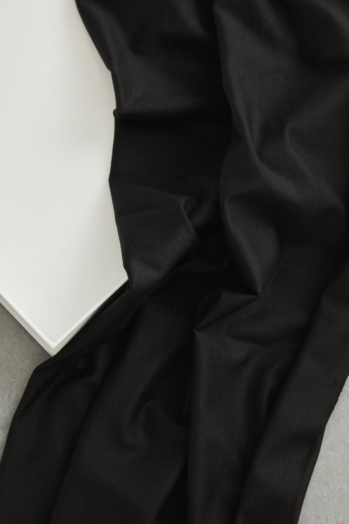 24/7 Stretch Lyocell Jersey in black, a drapey knit apparel fabric sold by the half yard, draped