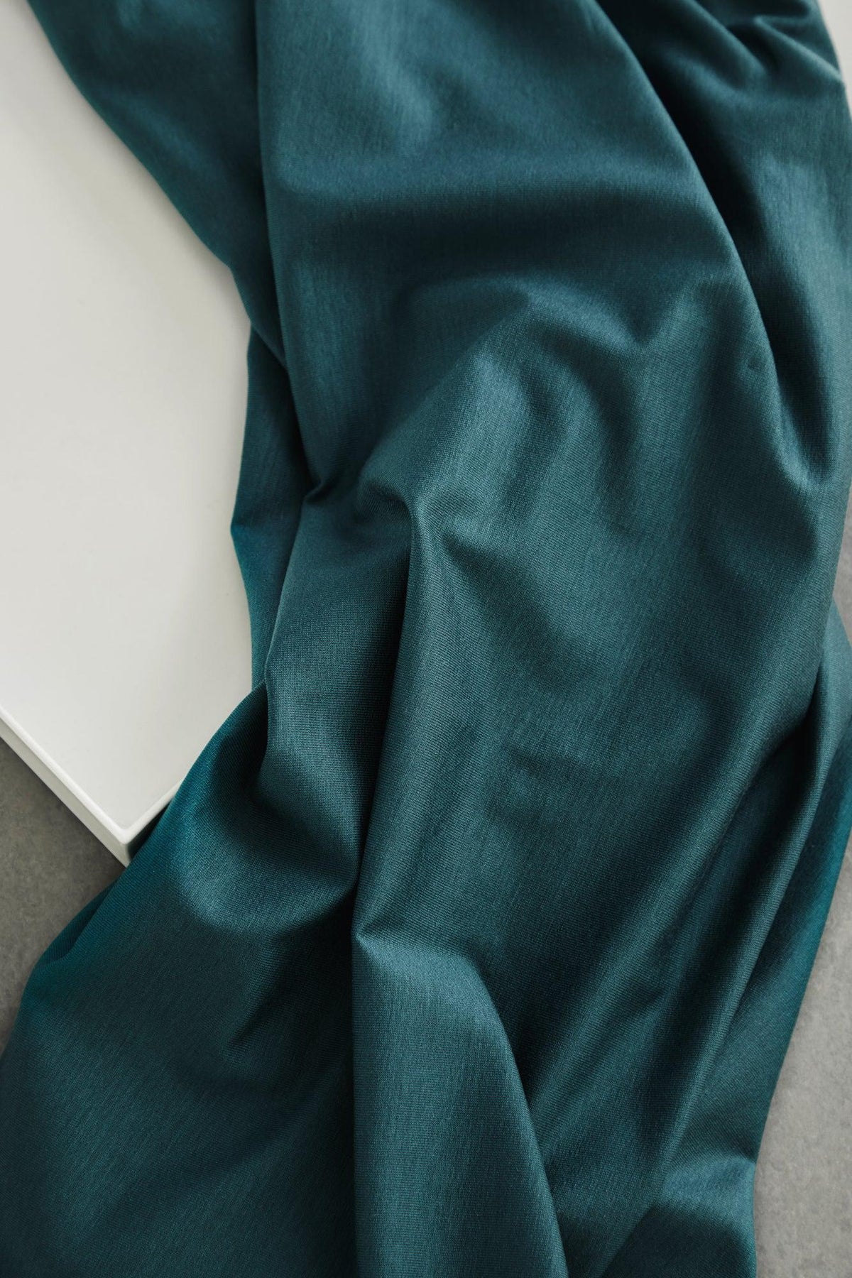 24/7 Stretch Lyocell Jersey in Pond, deep teal knit apparel fabric by the half yard draped