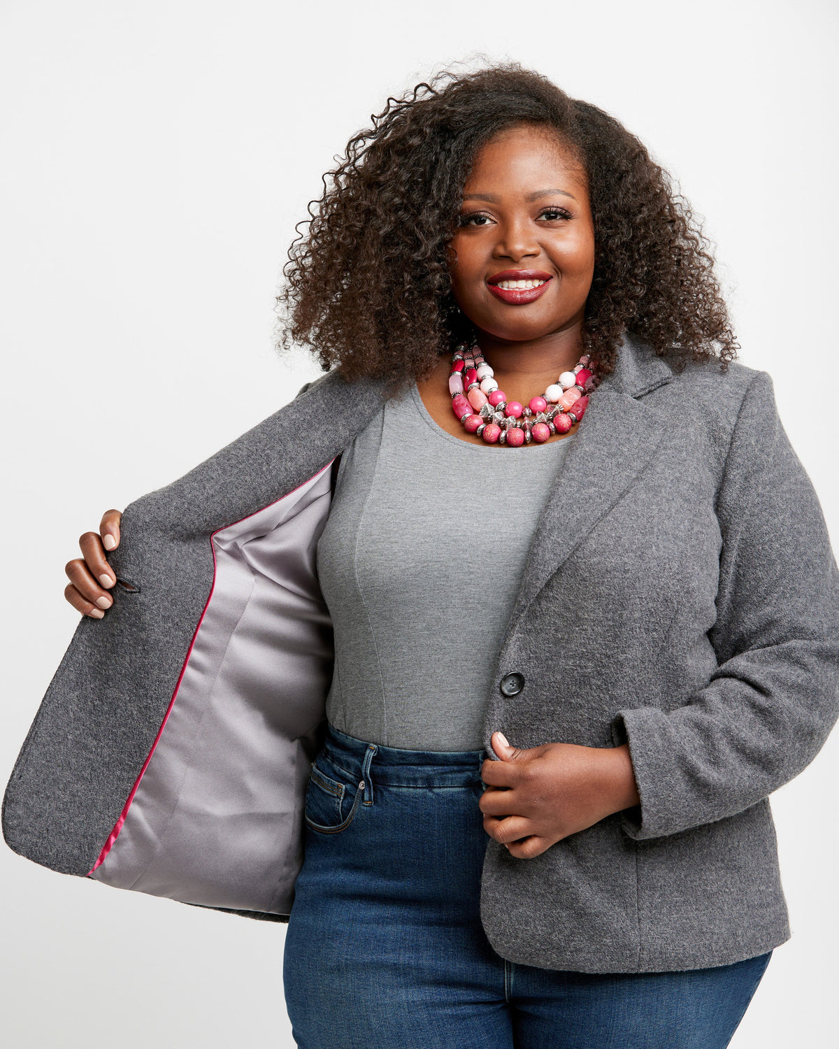 Cashmerette Auburn Blazer PDF sewing pattern, woman wearing a gray blazer with a red interior lining, standing