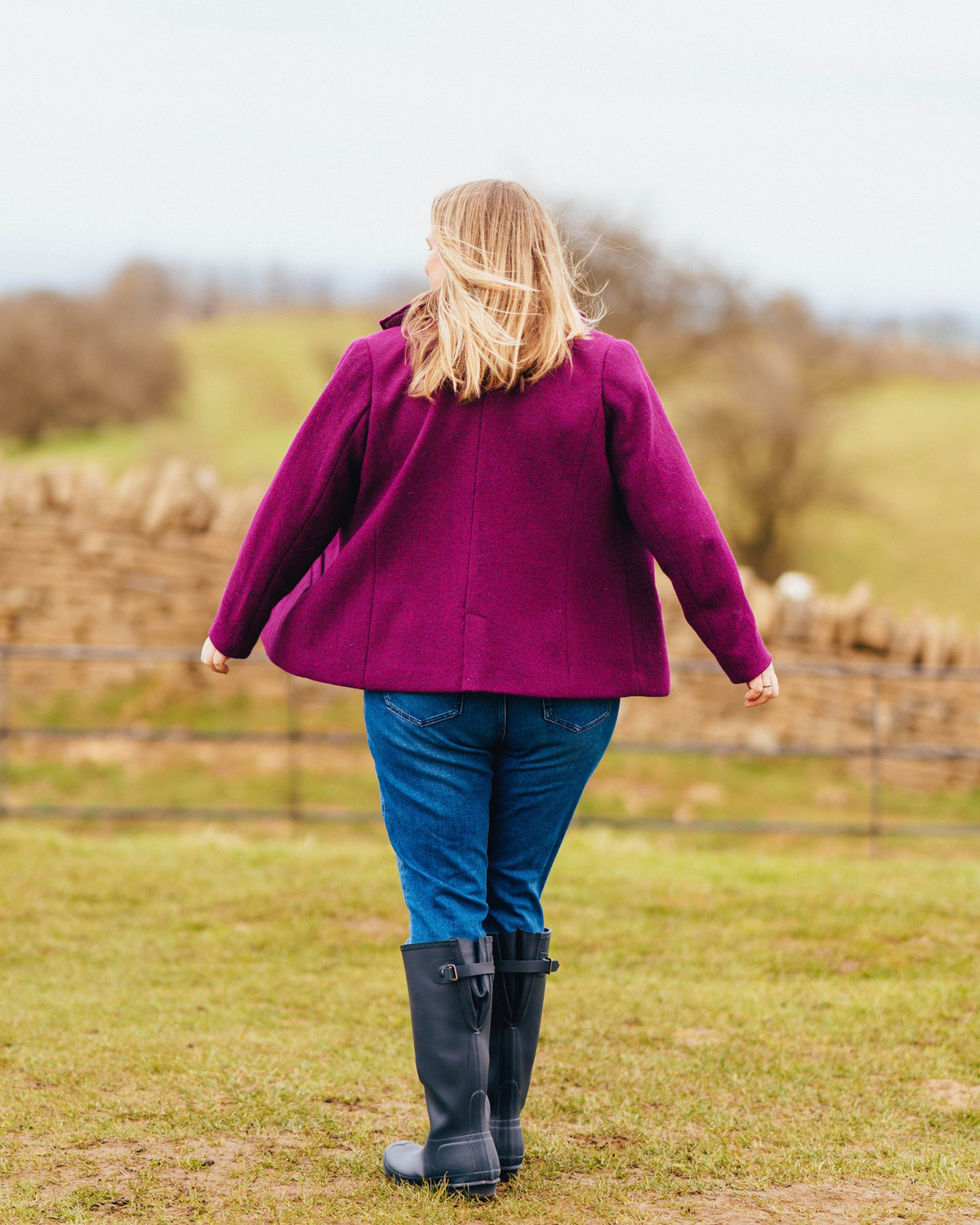 Cashmerette Auburn Blazer PDF sewing pattern, person wearing a purple coat and blue jeans standing in a field