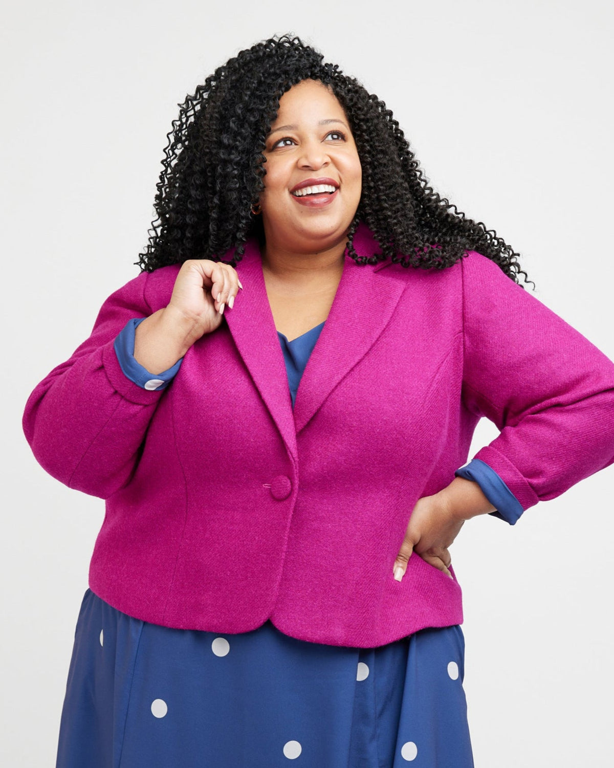 Cashmerette Auburn Blazer PDF sewing pattern, woman wearing a bright pink blazer over a blue dress with white polka and polka dot dress, front view