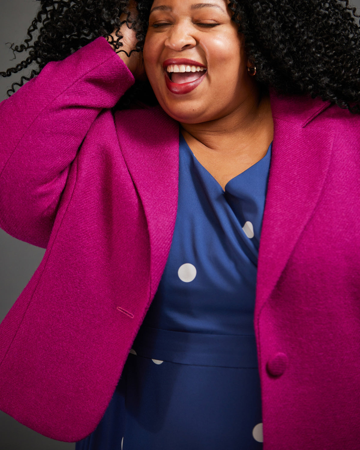 Cashmerette Auburn Blazer PDF sewing pattern, woman wearing a bright pink blazer over a blue dress with white polka dots, close-up