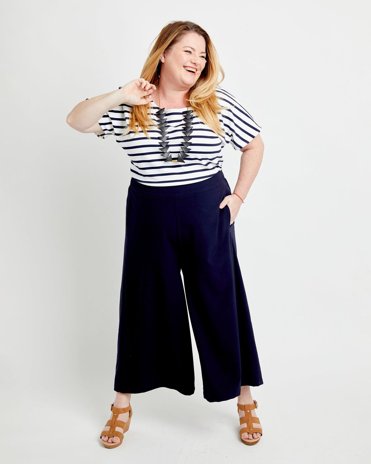 Cashmerette Calder Pants and Shorts PDF sewing pattern, woman wearing a striped shirt and navy wide-leg pants