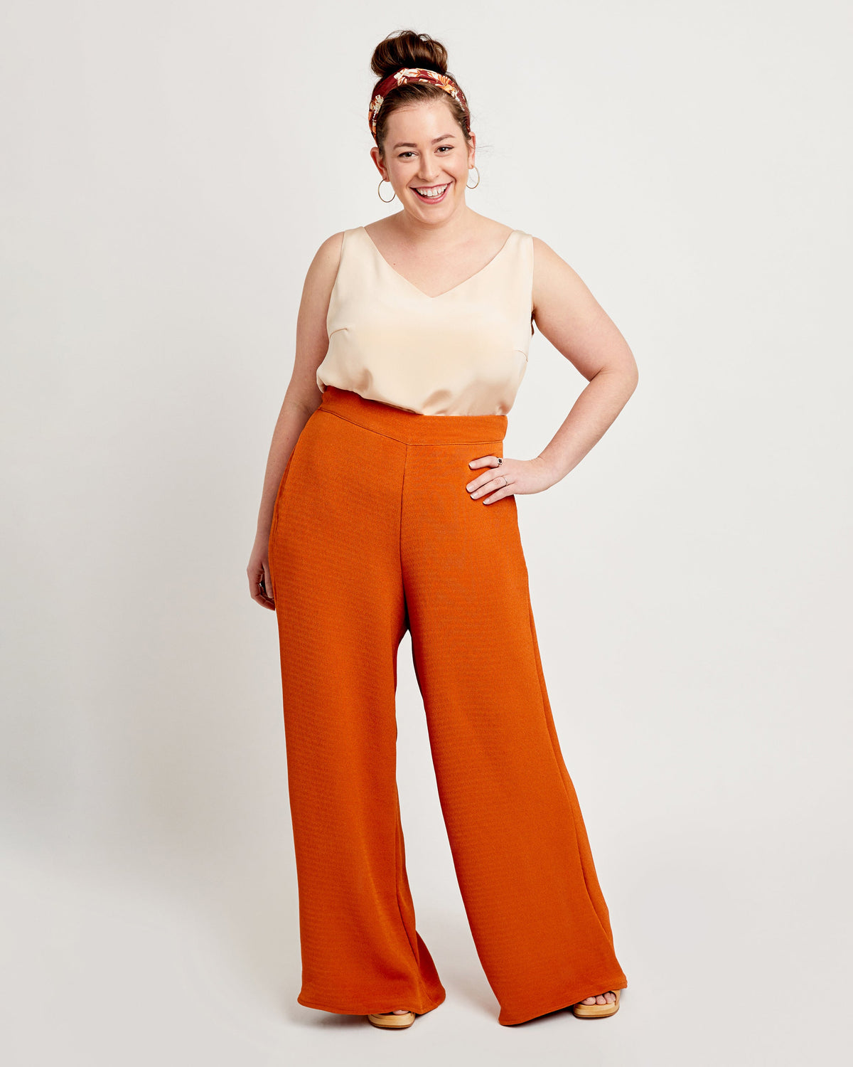 Cashmerette Calder Pants and Shorts PDF sewing pattern, woman wearing a cream top and orange wide-leg pants