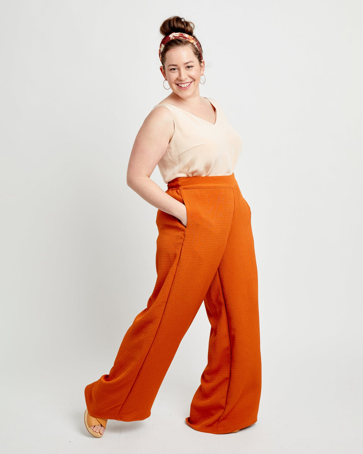 Cashmerette Calder Pants and Shorts PDF sewing pattern, woman wearing a beige top and orange wide-leg pants