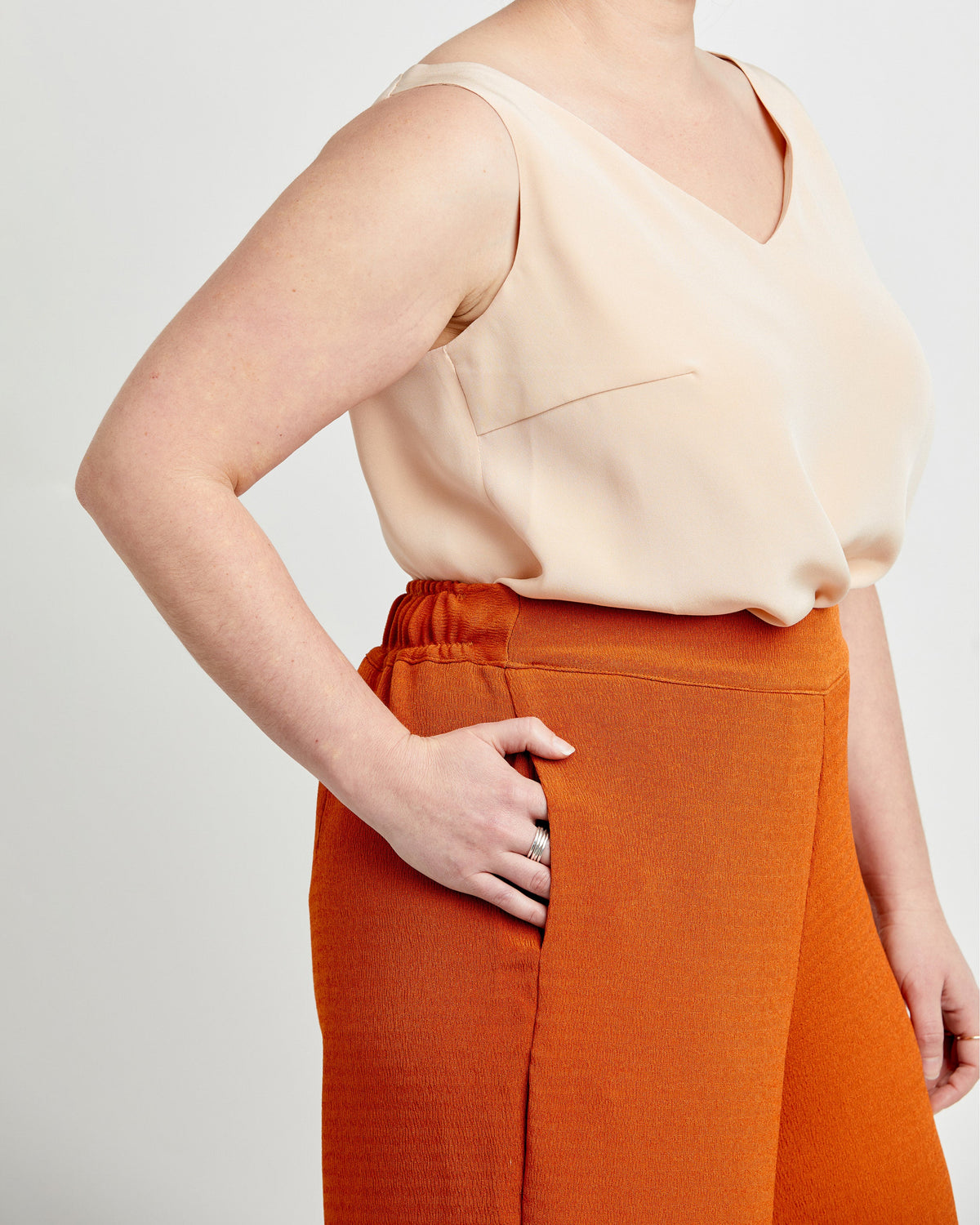 Cashmerette Calder Pants and Shorts PDF sewing pattern, person wearing a beige top and orange pants