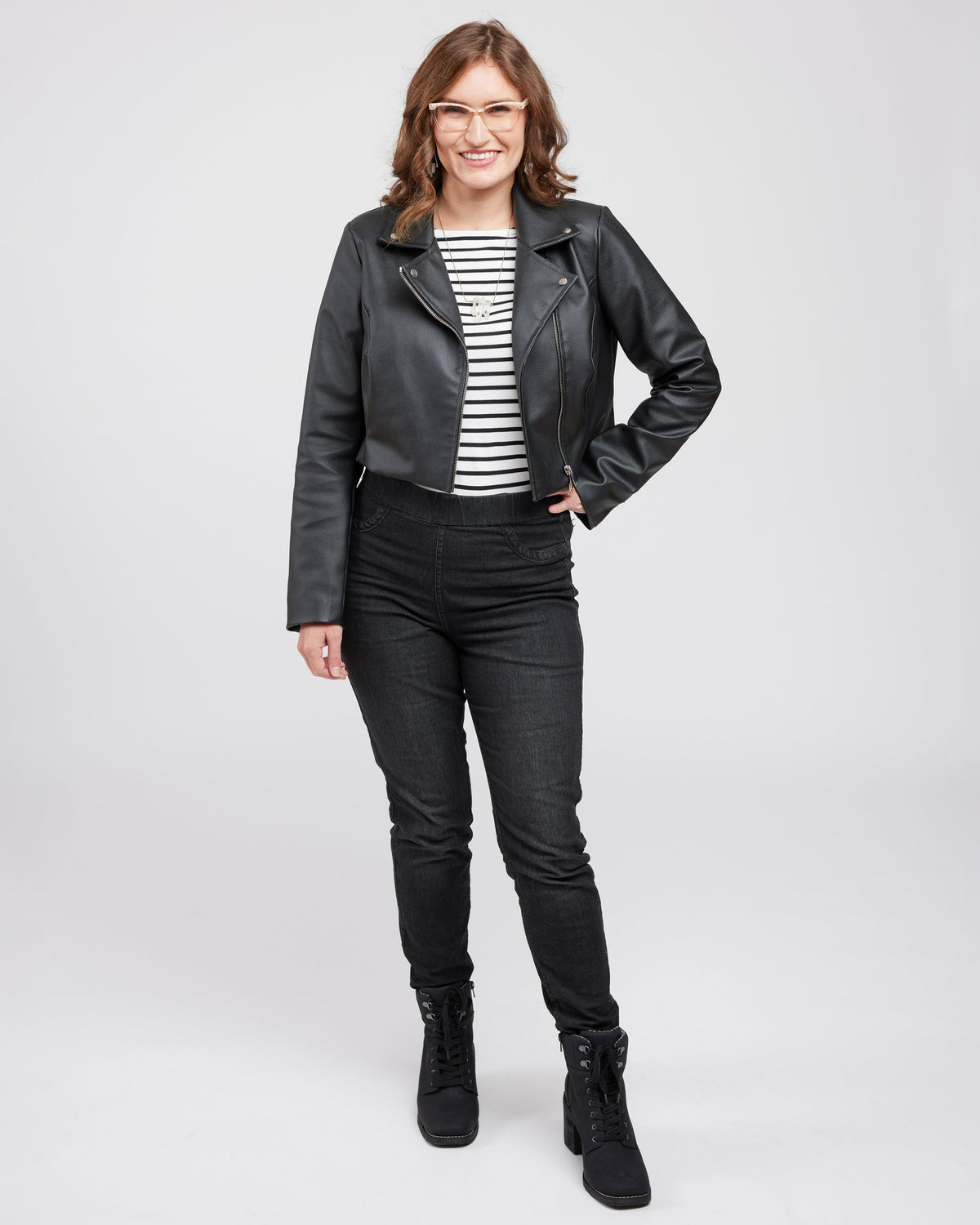 Cashmerette Canton Moto Jacket PDF sewing pattern, woman wearing a black leather jacket in front of a white wall