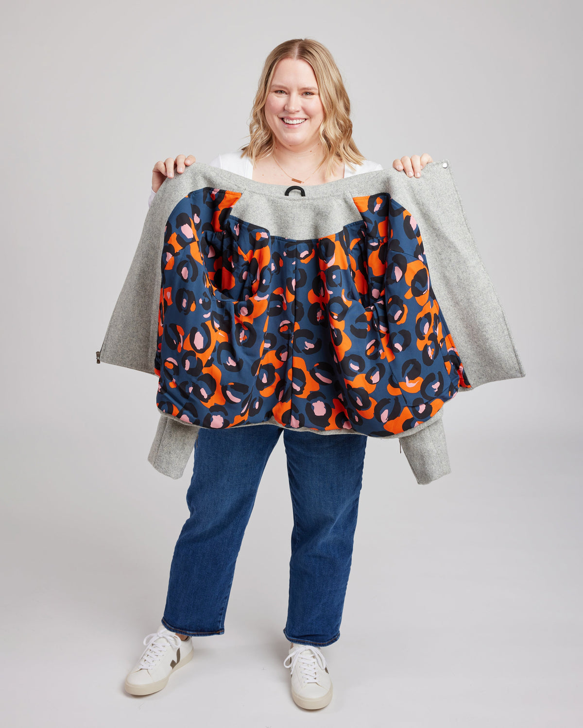 Cashmerette Canton Moto Jacket PDF sewing pattern, person holding a colorful patterned jacket