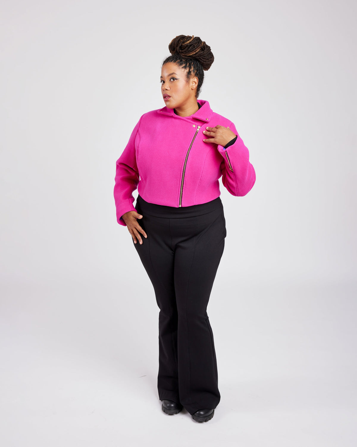 Cashmerette Canton Moto Jacket PDF sewing pattern, person wearing a bright pink hoodie with a zipper and black pants