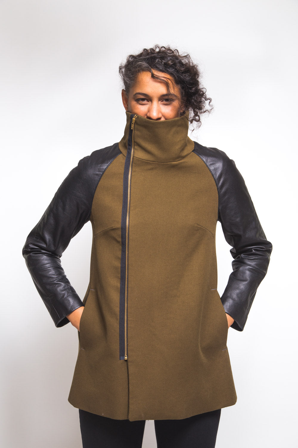 Side view of an olive and black coat made with the Closet Core Clare Coat sewing pattern