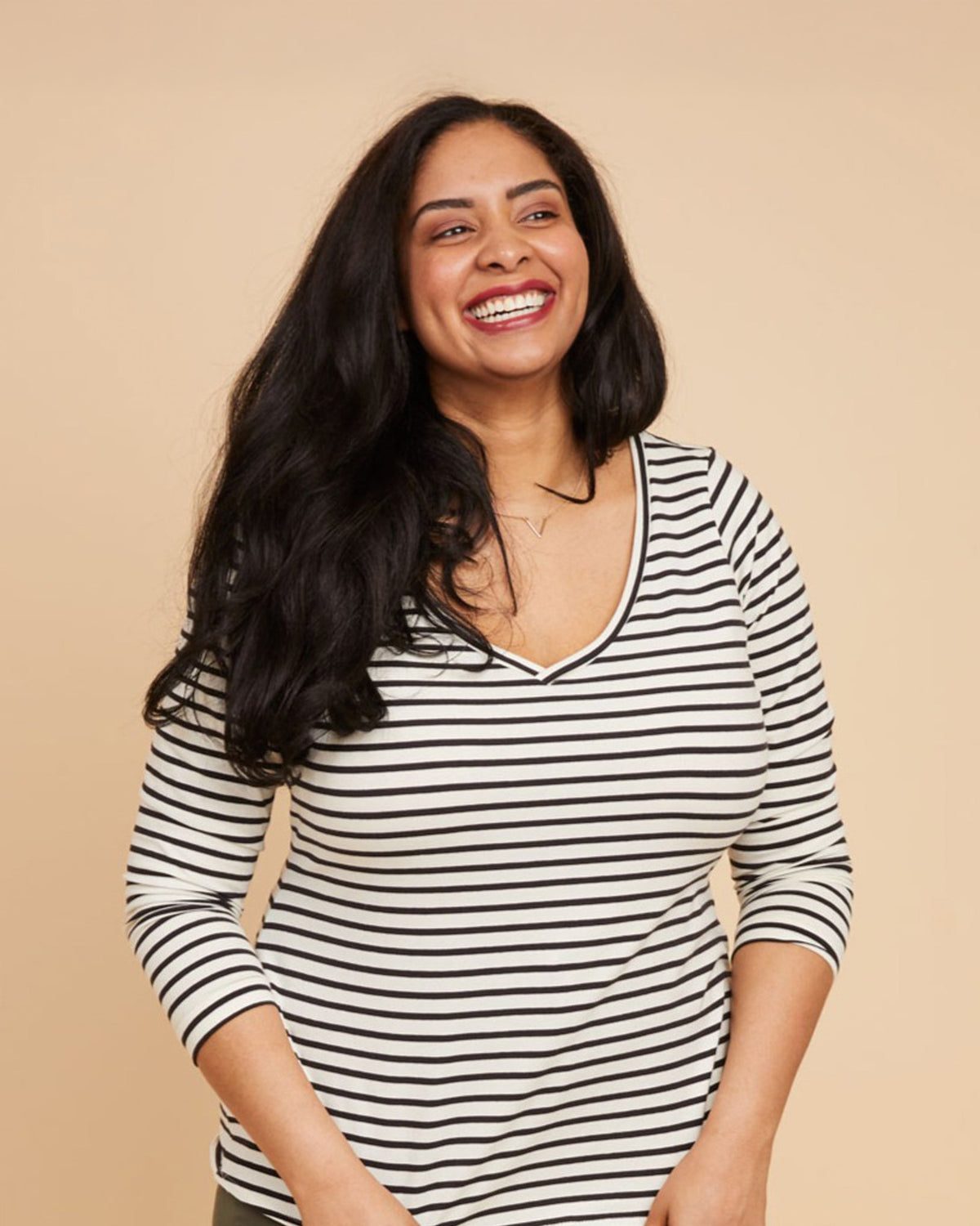 Cashmerette Concord T-Shirt PDF sewing pattern, woman wearing a black and white striped shirt against a beige backgroundThis t-shirt is the Concord