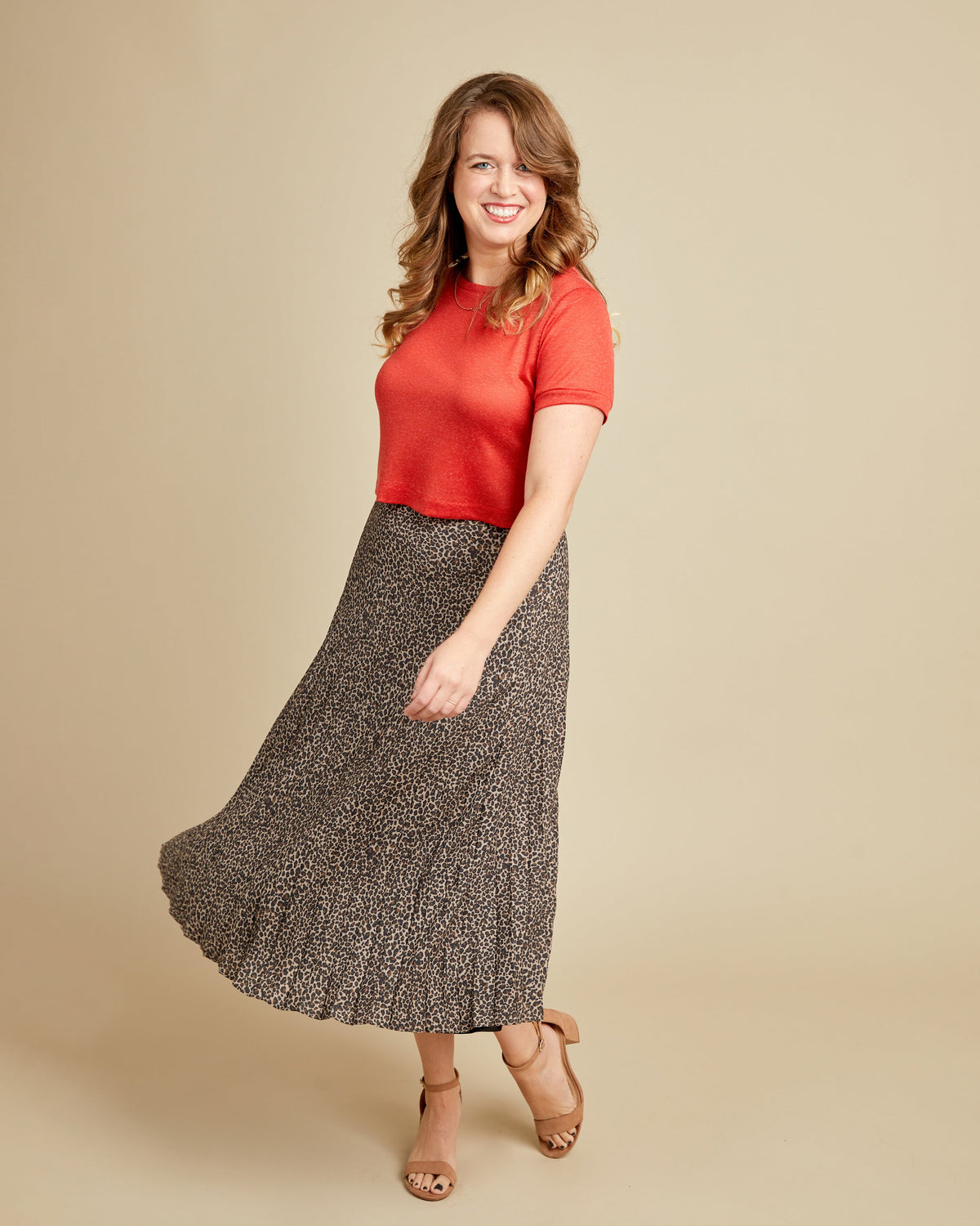 Cashmerette Concord T-Shirt PDF sewing pattern, woman wearing a red top and patterned skirt