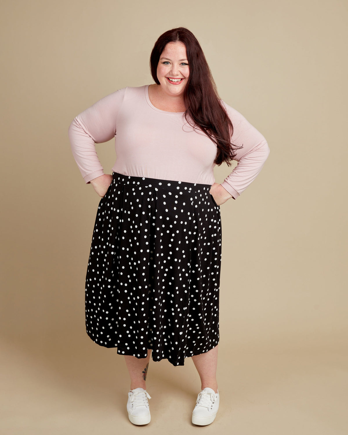 Cashmerette Concord T-Shirt PDF sewing pattern, woman wearing a pink top and black polka dot skirt