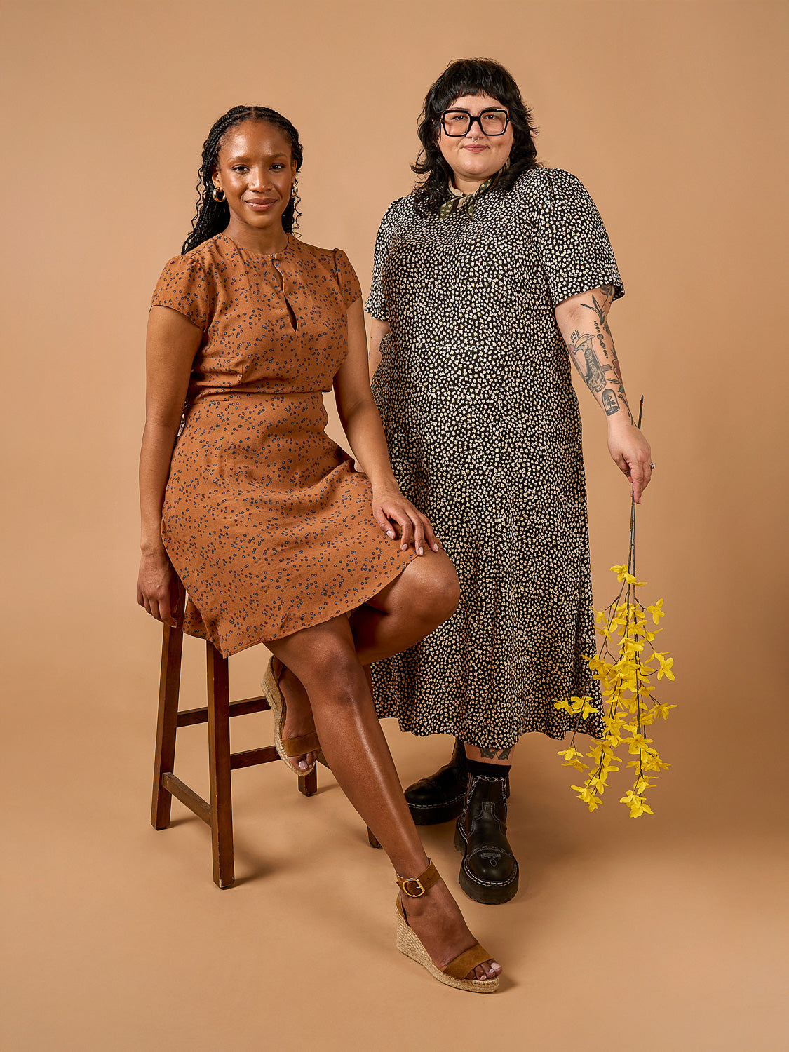 Deer & Doe Eleanor Dress sewing pattern, model in a red maxi dress against an orange wall