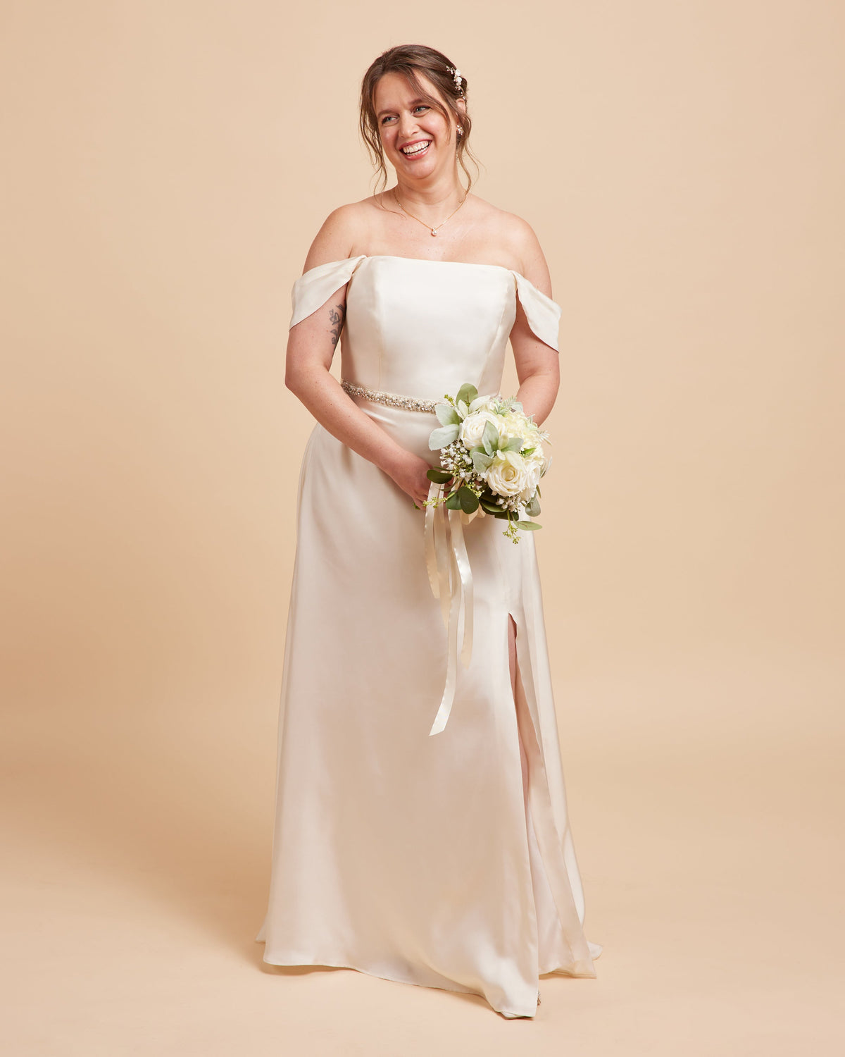 Cashmerette Ellington Dress PDF sewing pattern, woman in a white off-shoulder wedding dress holding a bouquet, full length