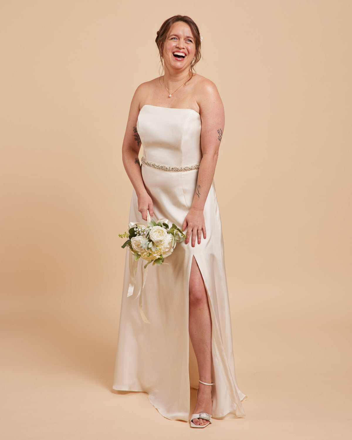 Cashmerette Ellington Dress PDF sewing pattern, woman in a strapless white wedding dress with a high slit, holding a bouquet