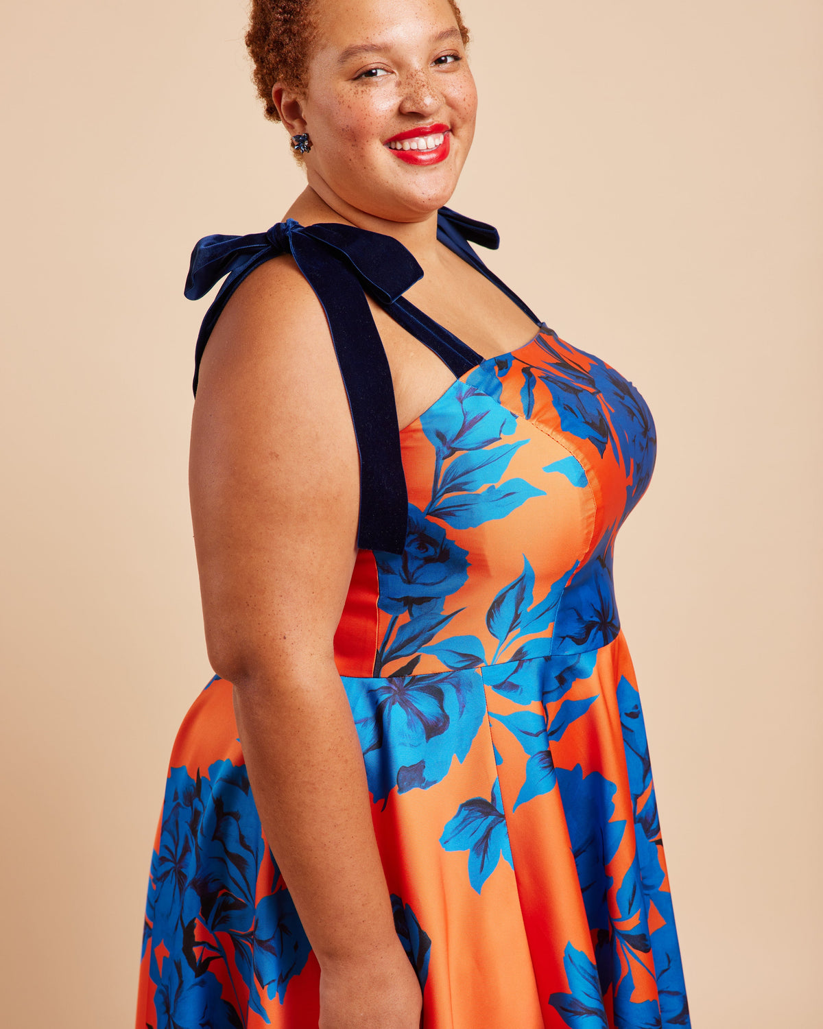 Cashmerette Ellington Dress PDF sewing pattern, woman wearing a colorful floral dress with a bow detail