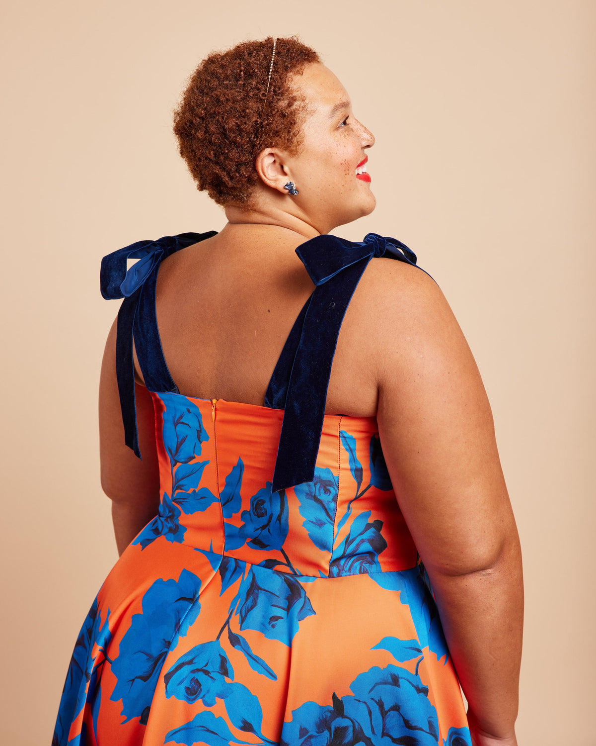 Cashmerette Ellington Dress PDF sewing pattern, woman wearing an orange and blue floral dress with bow straps