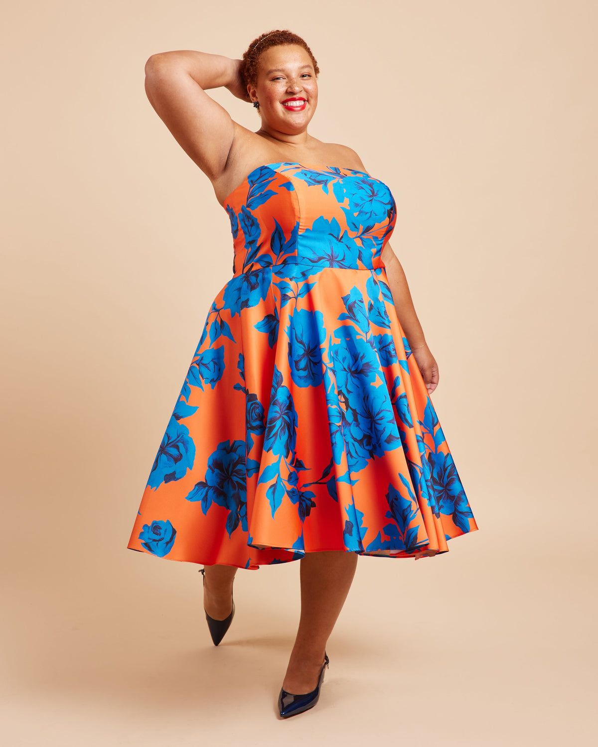 Cashmerette Ellington Dress PDF sewing pattern, woman wearing a strapless dress with orange and blue floral pattern