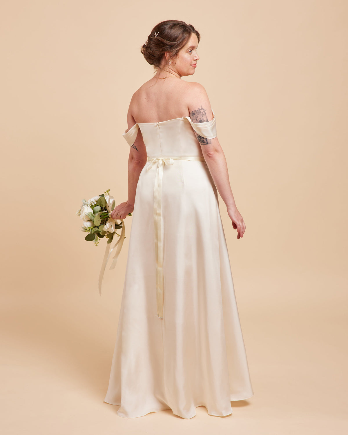 Cashmerette Ellington Dress PDF sewing pattern, woman in a white off-shoulder wedding dress holding a bouquet, off shoulder view