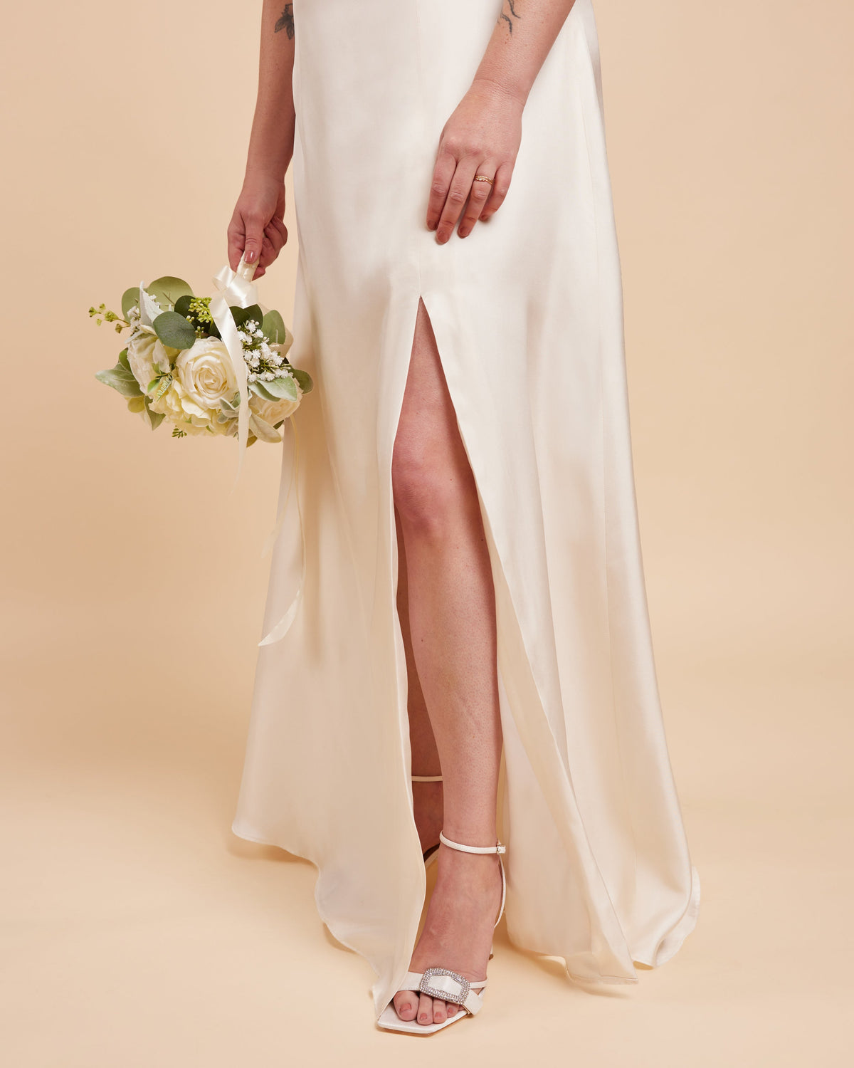 Cashmerette Ellington Dress PDF sewing pattern, woman in a white wedding dress with a high slit holding a bouquet
