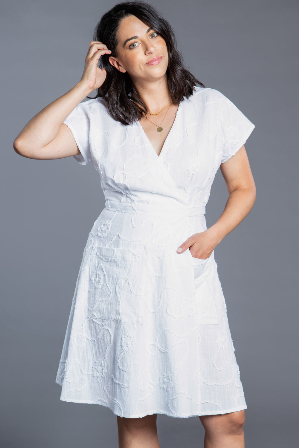 White knee length wrap dress made with the Closet Core Elodie Wrap Dress PDF sewing pattern