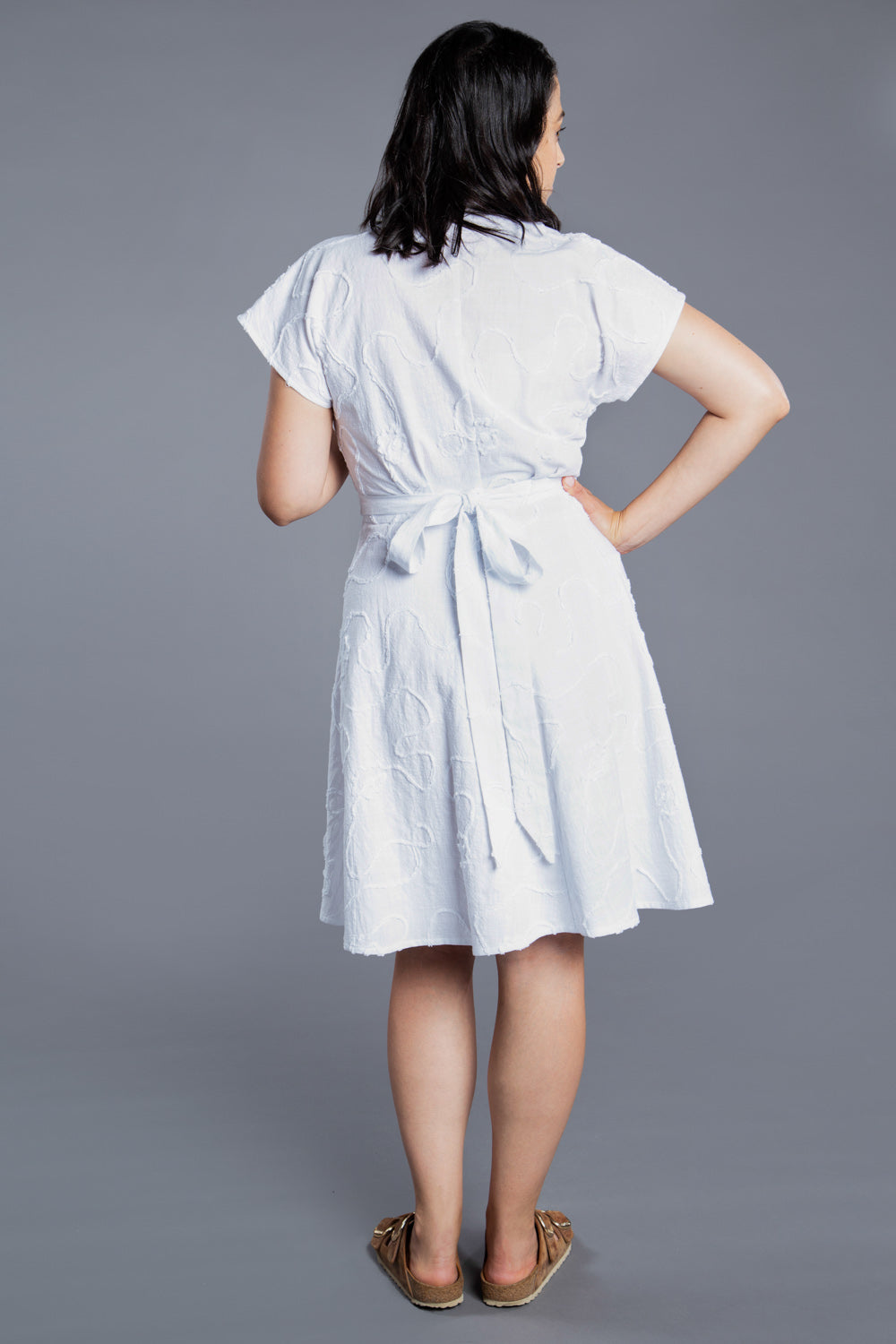 Back view of a white wrap dress with pockets, Closet Core Elodie Wrap Dress PDF sewing pattern