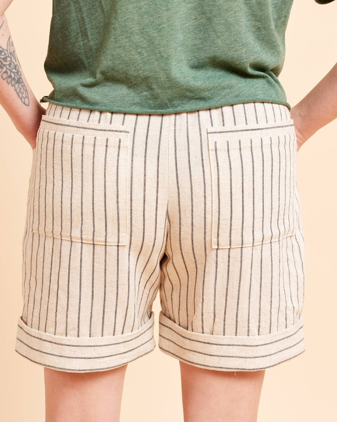 Cashmerette Everett Pants and Shorts PDF sewing pattern, beige shorts with black stripes worn by a person