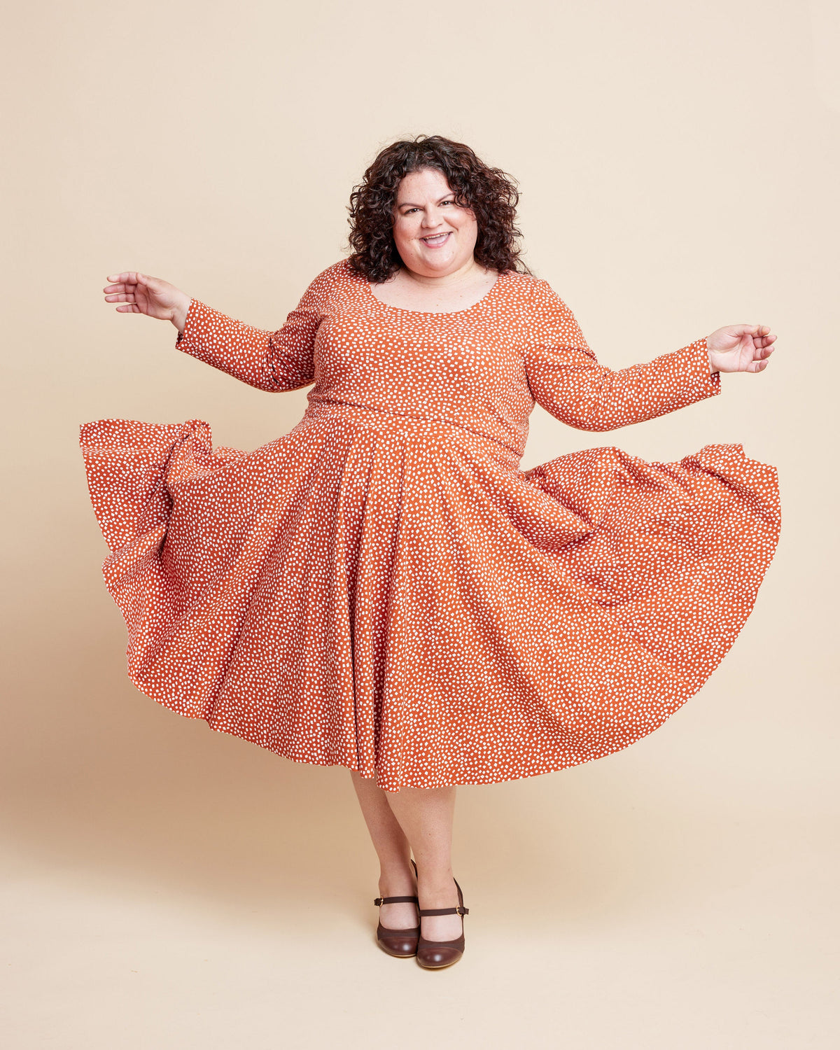 Cashmerette Grafton Dress, Top and Skirt PDF sewing pattern, woman wearing an orange patterned dress, twirling