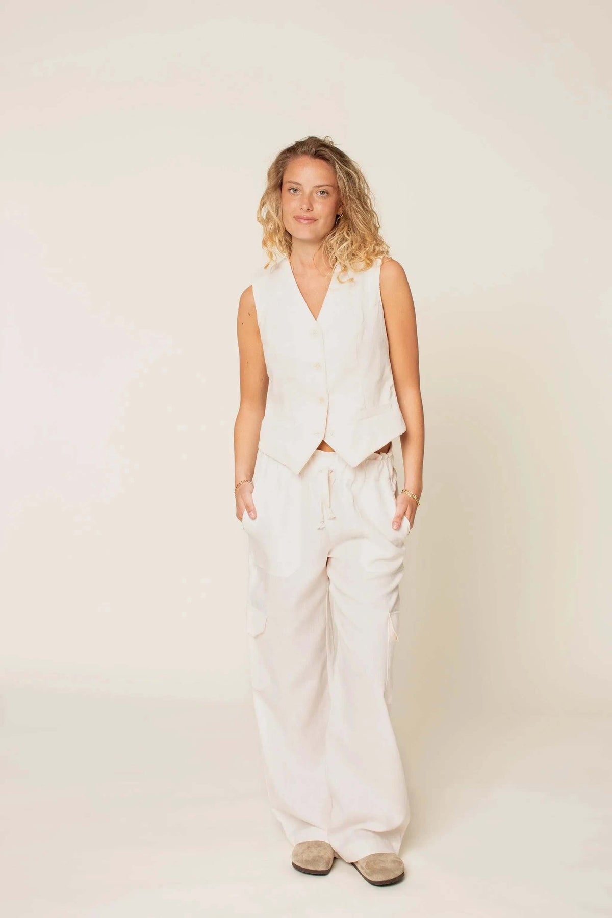 Wardrobe By Me High Waist Pants PDF sewing pattern, model in cream pants by a window