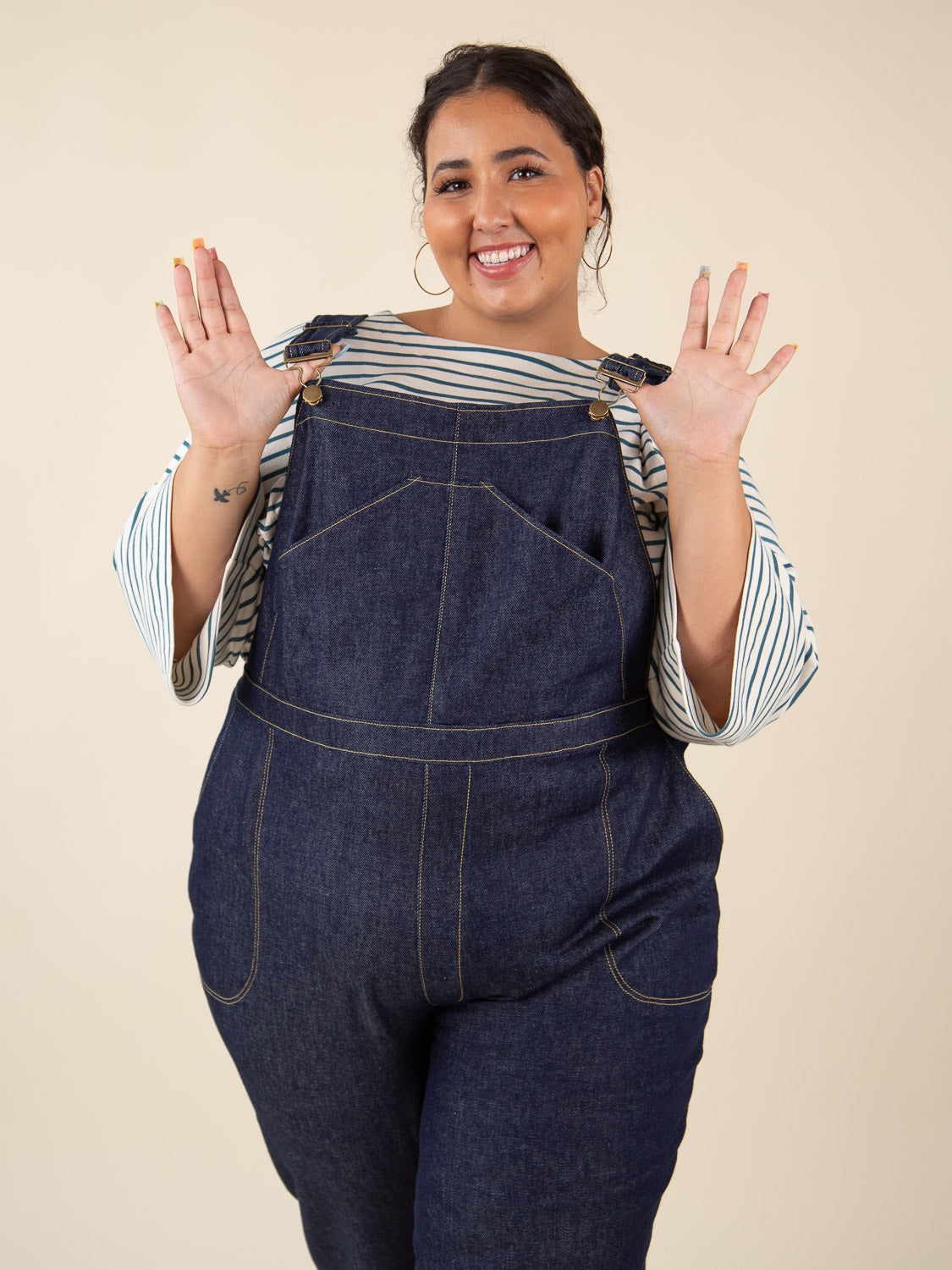 Navy overalls bib close-up with hands on straps, Closet Core Jenny Overalls and trousers PDF sewing pattern