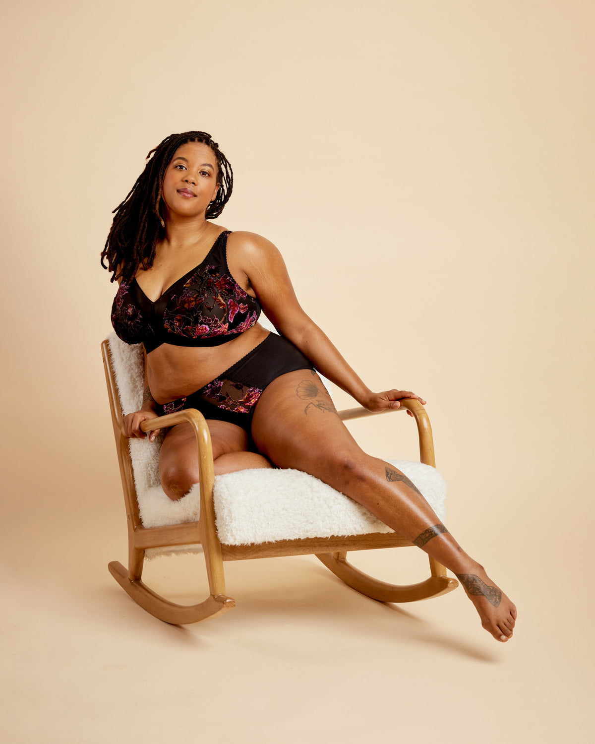 Cashmerette Loftus Bralette PDF sewing pattern, woman in black lingerie sitting on a rocking chair