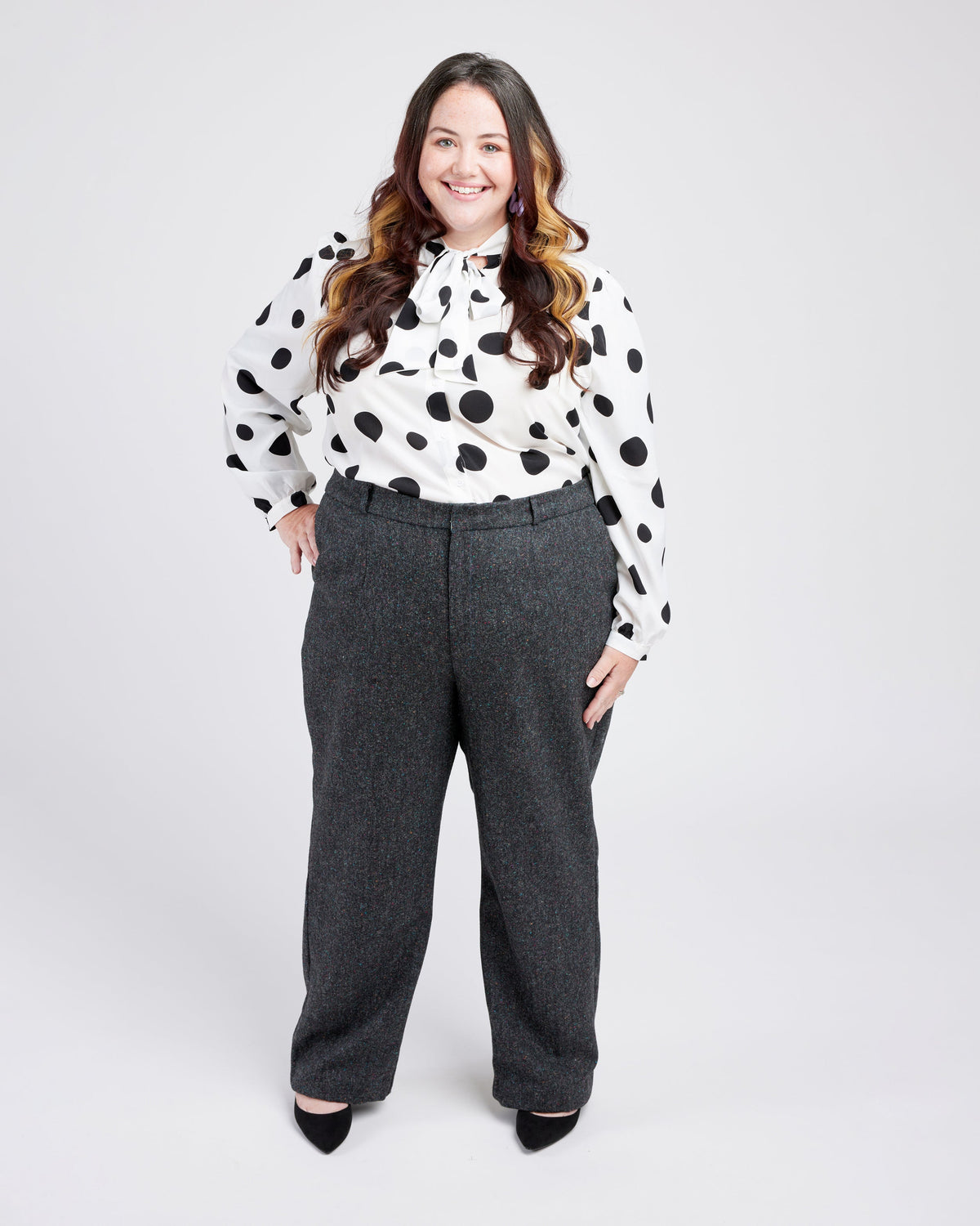 Cashmerette Meriam Trousers PDF sewing pattern, woman wearing a polka dot blouse and gray pants, front view