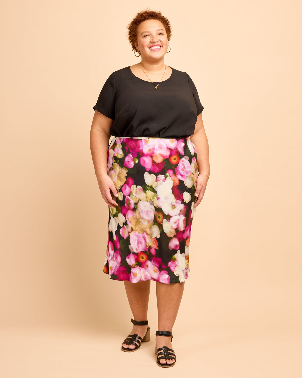 Cashmerette Montrose Top PDF sewing pattern, woman wearing a black top and floral skirt, front view