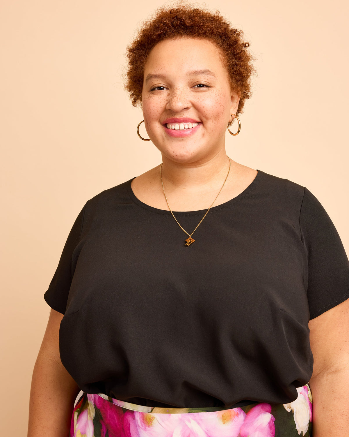 Cashmerette Montrose Top PDF sewing pattern, woman wearing a black top with floral pants