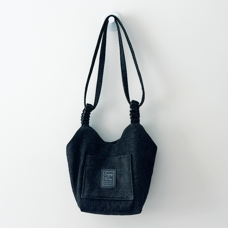 Sewing Therapy Bridge Bag PDF sewing pattern, black bag held by the handle
