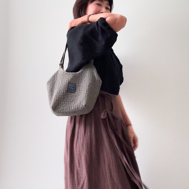 Sewing Therapy Bridge Bag PDF sewing pattern, black bag carried at hip