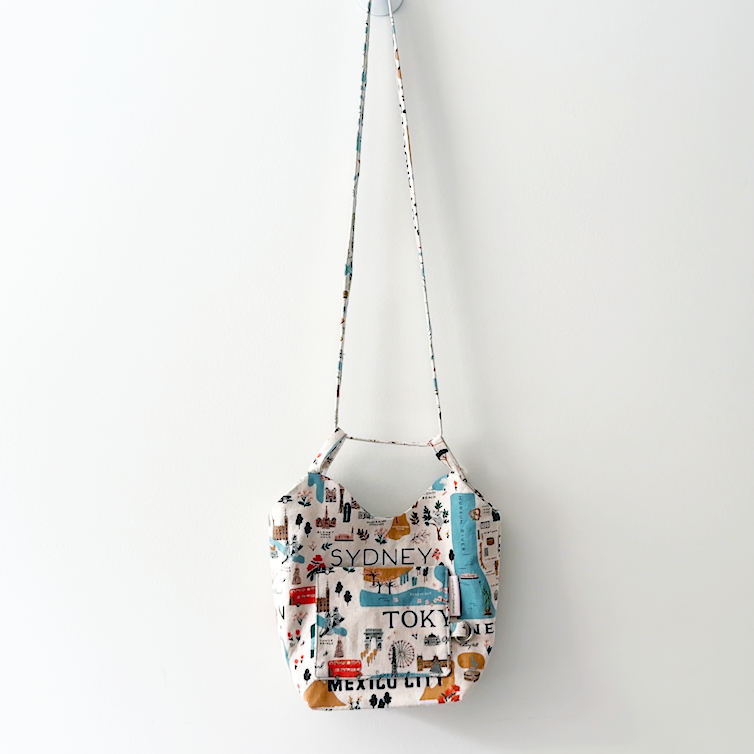 Sewing Therapy Bridge Bag PDF sewing pattern, floral bag hanging by the strap