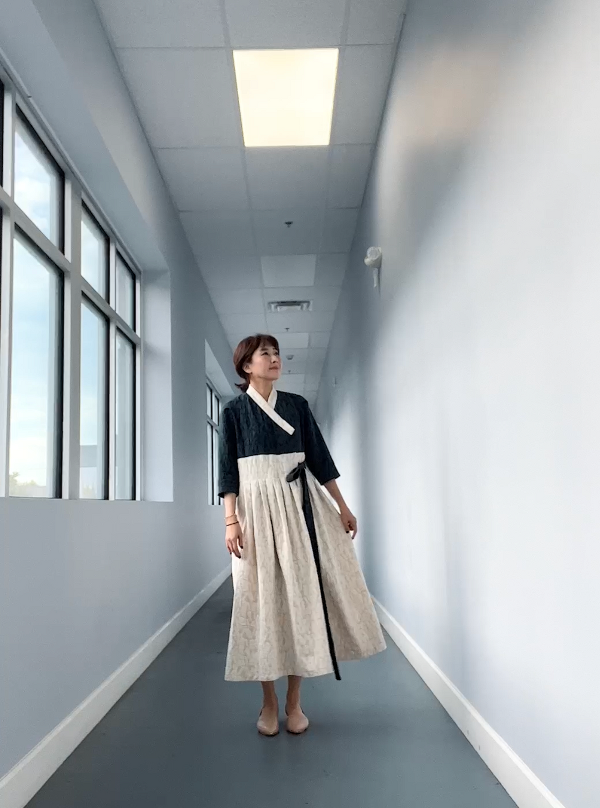 Sewing Therapy Hanbok Wrap Dress PDF sewing pattern, navy dress walking in a hallway