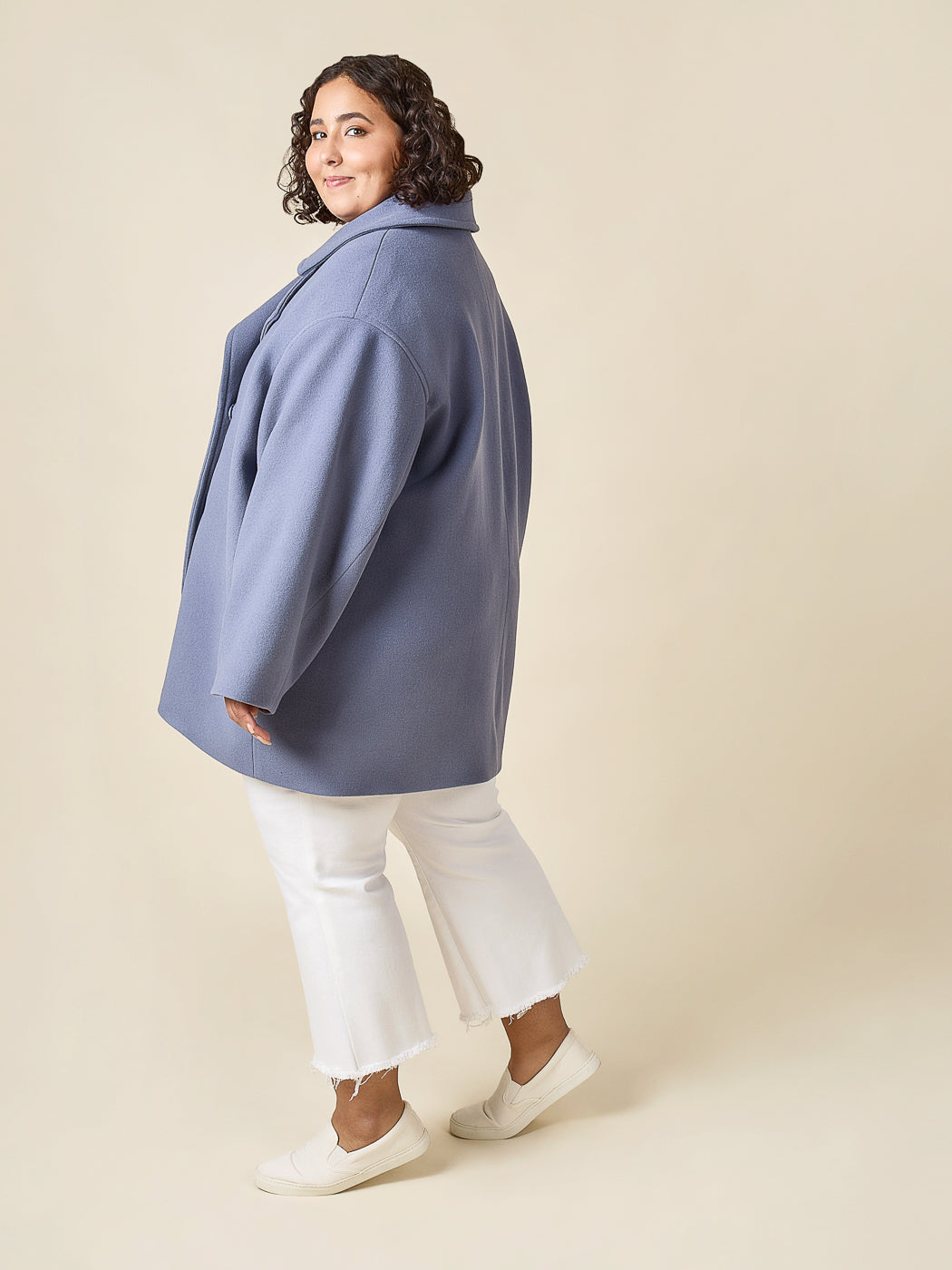 Side view of a blue cropped coat made with the Closet Core Phoebe Coat PDF sewing pattern